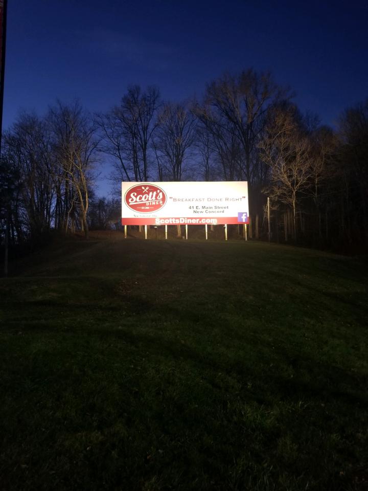 Scott's Diner billboard at night.